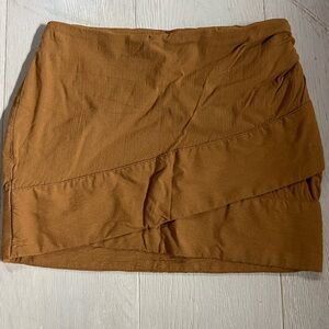 Free People Anthropologie tiered mini skirt in a mustard tan color.